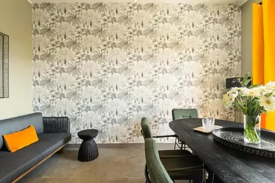 a living room with a couch and a table and a wall at Cozy apartment Gianicolense 3bdr in Rome