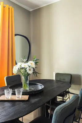 a dining room table with a vase of flowers on it at Cozy apartment Gianicolense 3bdr in Rome