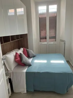 a bedroom with a bed with pillows on it at Sant'Angelo House in Rome