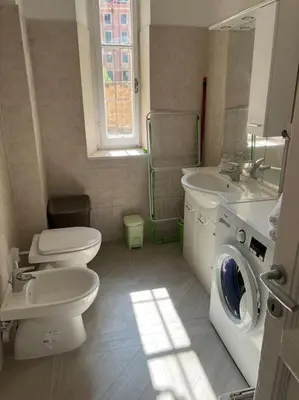 a bathroom with a toilet sink and a washing machine at Sant'Angelo House in Rome