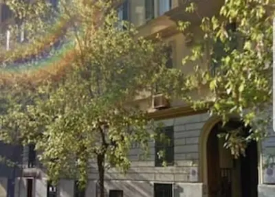 a tree in front of a building with a rainbow at Sant'Angelo House in Rome