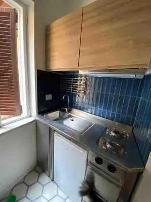 a small kitchen with a sink and a stove at Casa Claudia ~ rione Monti-Colosseo in Rome