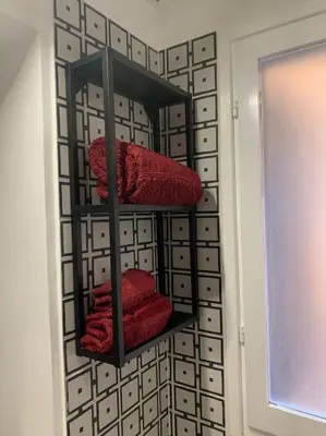 a towel rack with red towels on a wall at Casa Claudia ~ rione Monti-Colosseo in Rome