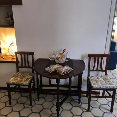 a table with two chairs and a bowl and glasses on it at Casa Claudia ~ rione Monti-Colosseo in Rome