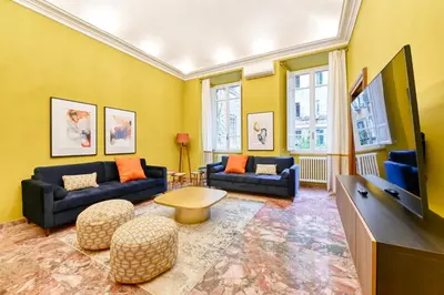 a living room with couches and a flat screen tv at Elegant oasis among the Vatican and Via del Corso in Rome