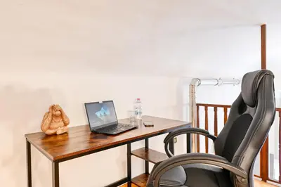 a desk with a laptop and a chair at Elegant oasis among the Vatican and Via del Corso in Rome