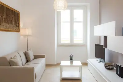 a white living room with a couch and a table at Taurasia By Rental in Rome in Rome