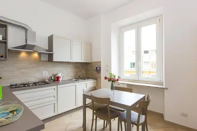 a kitchen with a table and chairs and a window at Taurasia By Rental in Rome in Rome