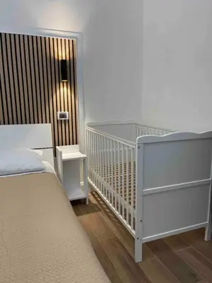 a bedroom with a crib at Avocado House - Cozy Apartment in the Heart of Rome in Rome