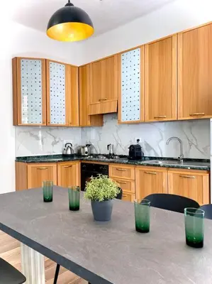 a kitchen with a table with green plants on it at Avocado House - Cozy Apartment in the Heart of Rome in Rome
