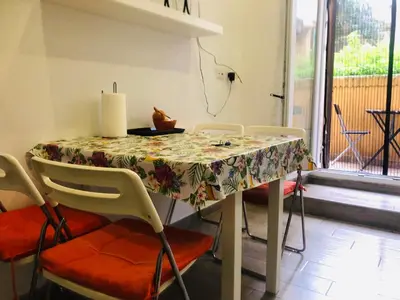 a dining room table with a flowered table cloth at Colibrì Apartment in Rome