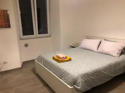 a bedroom with a bed with a towel on it at Colibrì Apartment in Rome