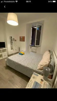 a bedroom with a large bed and a table at Colibrì Apartment in Rome