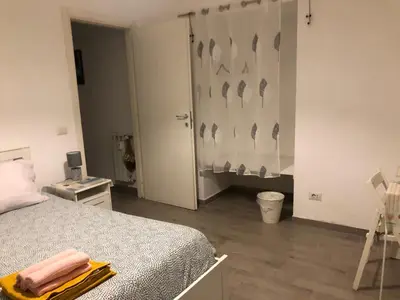 a bedroom with a bed and a wall with birds on it at Colibrì Apartment in Rome