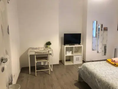 a small room with a desk and a television at Colibrì Apartment in Rome
