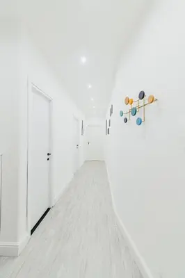 an empty hallway with white walls and a white floor at Casa Boccea 112 in Rome