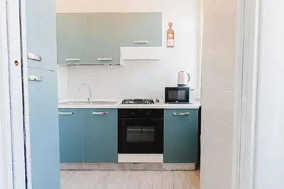 a kitchen with blue cabinets and a sink at Casa Boccea 112 in Rome
