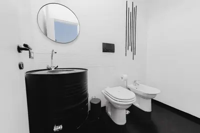 a bathroom with a sink and a toilet and a mirror at Casa Boccea 112 in Rome