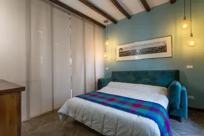 a bedroom with a bed with a colorful blanket on it at Frangipane 31 Monti Terrace in Rome