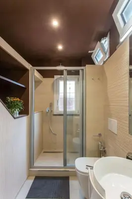 a bathroom with a shower and a toilet and a sink at Frangipane 31 Monti Terrace in Rome