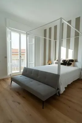 a bedroom with a canopy bed and a couch at Casa Mirabella in Rome