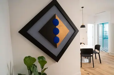 a dining room with a painting on the wall at Casa Mirabella in Rome