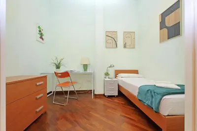 a bedroom with a bed and a desk with a chair at 4BNB - Cimabue Apartment in Rome