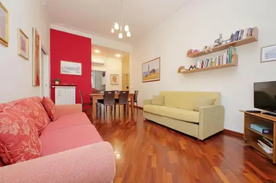 a living room with a couch and a tv and a table at 4BNB - Cimabue Apartment in Rome
