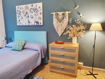 a bedroom with a bed and a dresser with a lamp at Da Licia in Rome