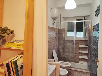 a bathroom with a toilet and a glass shower at Da Licia in Rome