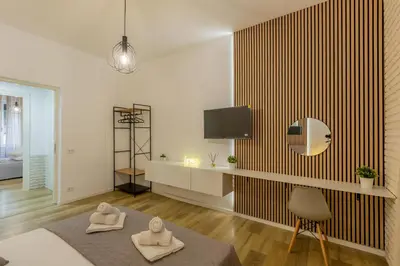 a living room with two towels on a table at Imperium House - appartamento con giardino privato, 3 minuti da Metro Piazza Bologna, A-C, in Rome