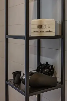 a black shelf with a box and a plate at Imperium House - appartamento con giardino privato, 3 minuti da Metro Piazza Bologna, A-C, in Rome