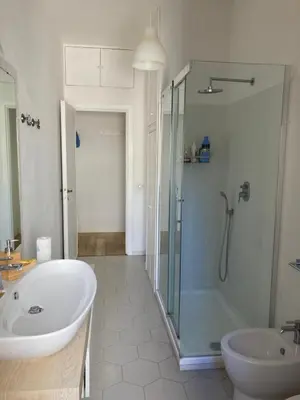 a bathroom with a shower and a tub and a sink at Casa Caravella in Rome