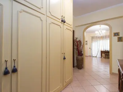 a hallway with white cabinets and an entry way at Apartment Vaticanum Hills by Interhome in Rome