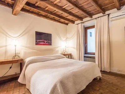 a bedroom with a large bed and a window at Apartment Augustus by Interhome in Rome