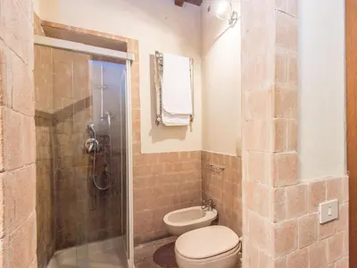 a bathroom with a toilet and a glass shower at Apartment Augustus by Interhome in Rome