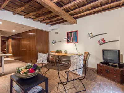 a living room with a table and a television at Apartment Augustus by Interhome in Rome