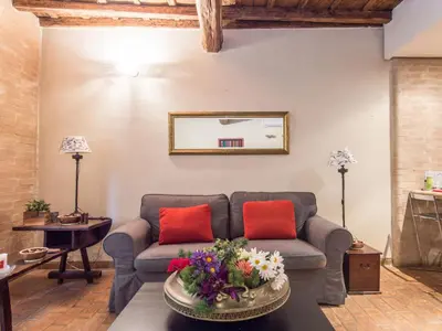 a living room with a couch and red pillows at Apartment Augustus by Interhome in Rome
