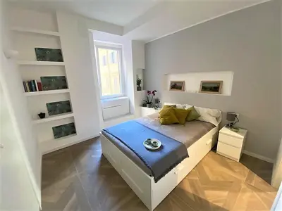 a bedroom with a bed and a large window at La casa di Jonathan al Ghetto in Rome
