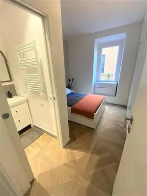 a small bedroom with a bed and a window at La casa di Jonathan al Ghetto in Rome