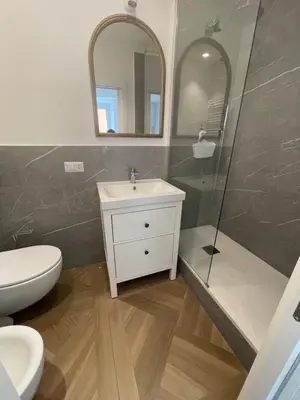 a bathroom with a toilet and a sink and a shower at La casa di Jonathan al Ghetto in Rome