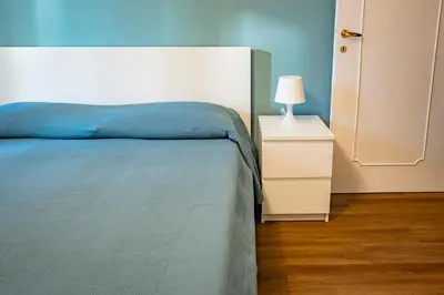 a bedroom with a bed and a night stand with a lamp at Limacino in Rome