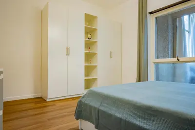 a white bedroom with a bed and a window at Limacino in Rome