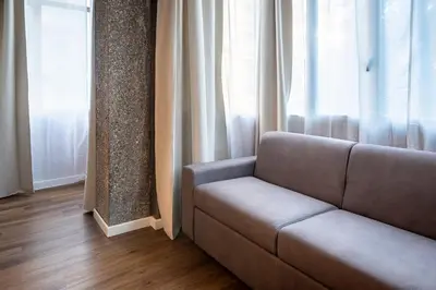a living room with a couch and a window at Limacino in Rome