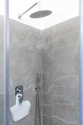 a bathroom with a shower with a toilet and a sink at La casa di Jojo al Ghetto in Rome