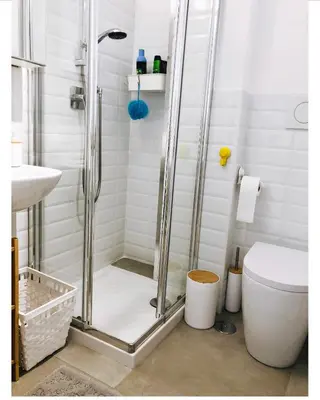 a bathroom with a shower with a toilet and a sink at A Casa di Lele in Rome