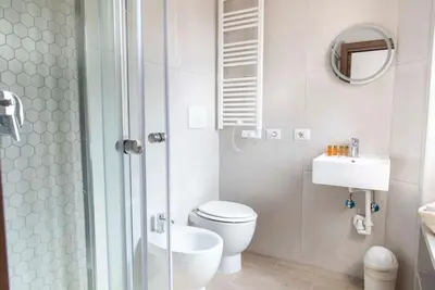 a bathroom with a toilet and a sink and a shower at Domus Viola in San Giovanni in Rome