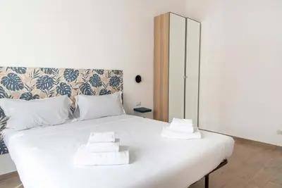 a white bed with two pillows on top of it at Domus Viola in San Giovanni in Rome