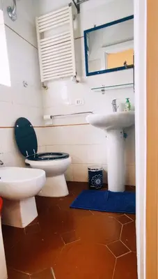 a bathroom with a toilet and a sink at Casetta del Quadraro in Rome
