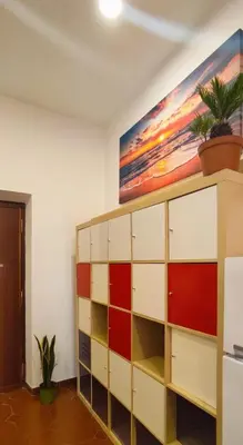 a shelf in a room with a painting on the wall at Casetta del Quadraro in Rome